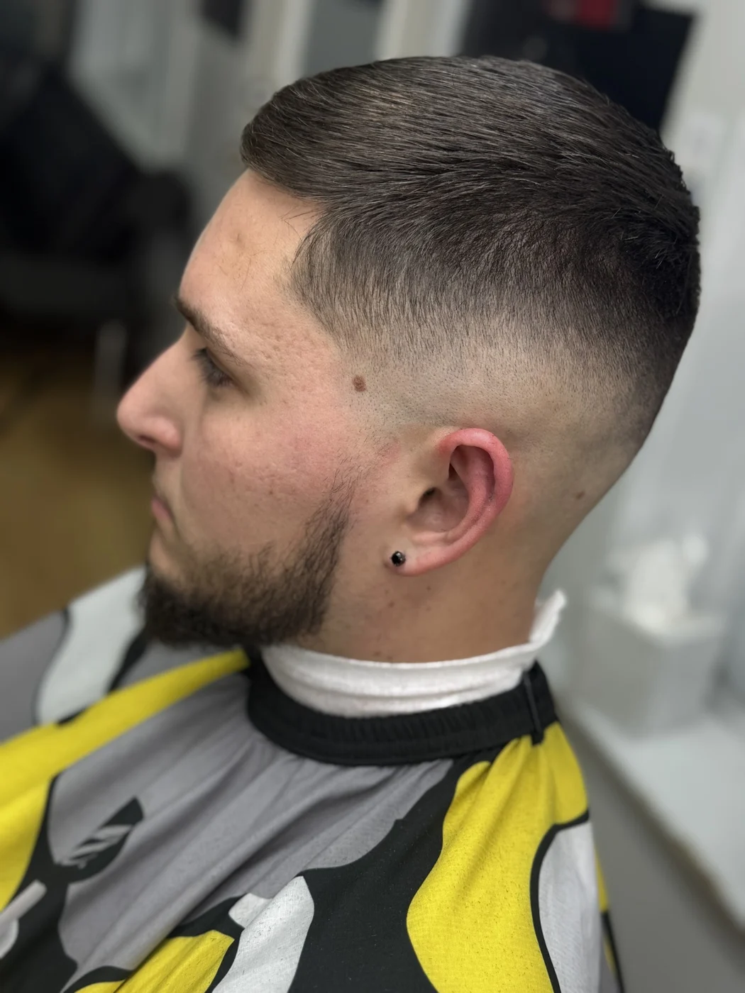 A finished short haircut with a clean fade from Clever Cutz's business profile