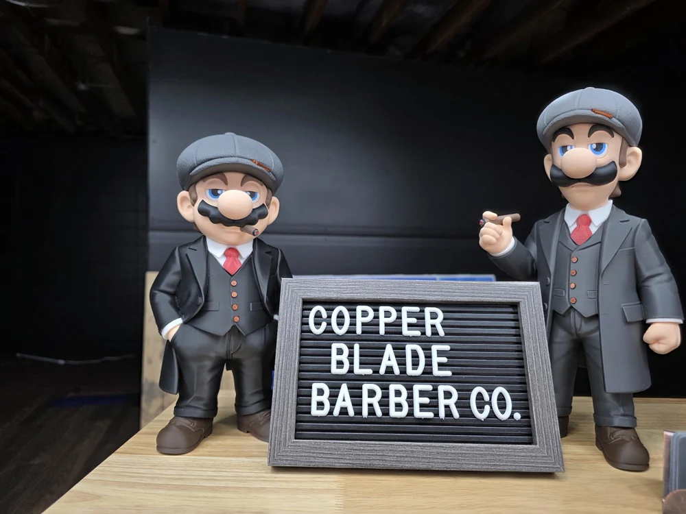Copper Blade Barber Co. letterboard and figures inside the shop