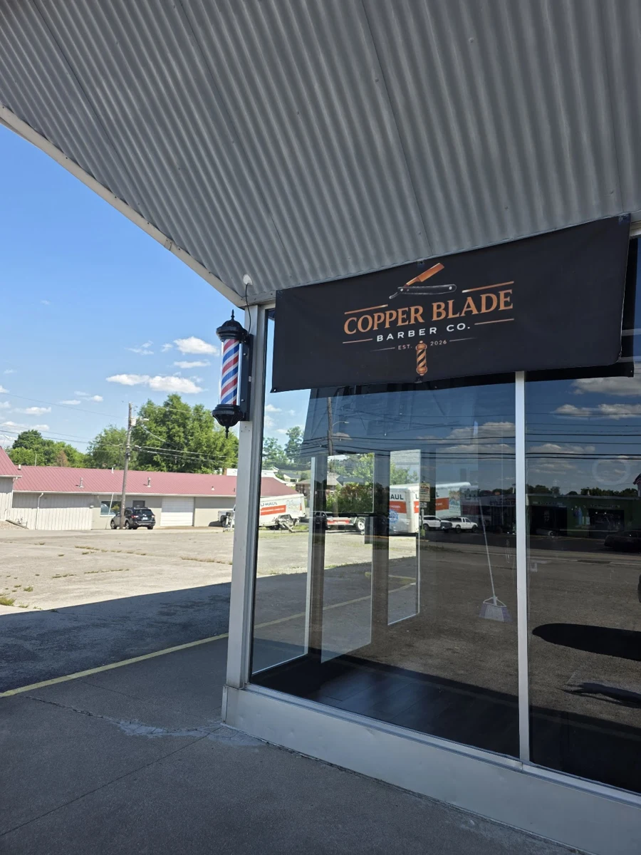 Copper Blade’s storefront and entrance beneath the covered walkway at 434 West Main Street