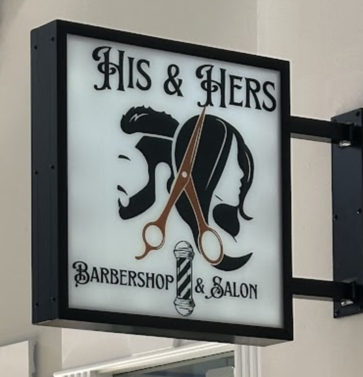 Photographed His and Hers storefront sign with scissors, barber pole and silhouettes
