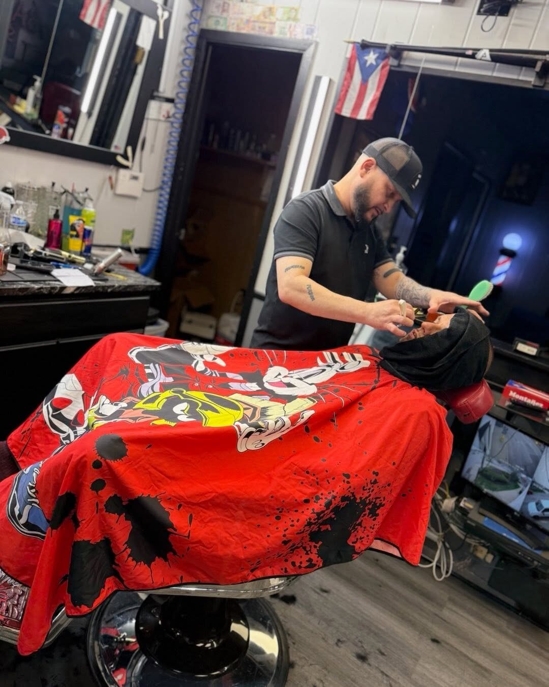 A barber working inside MVB Most Valuable Barbers