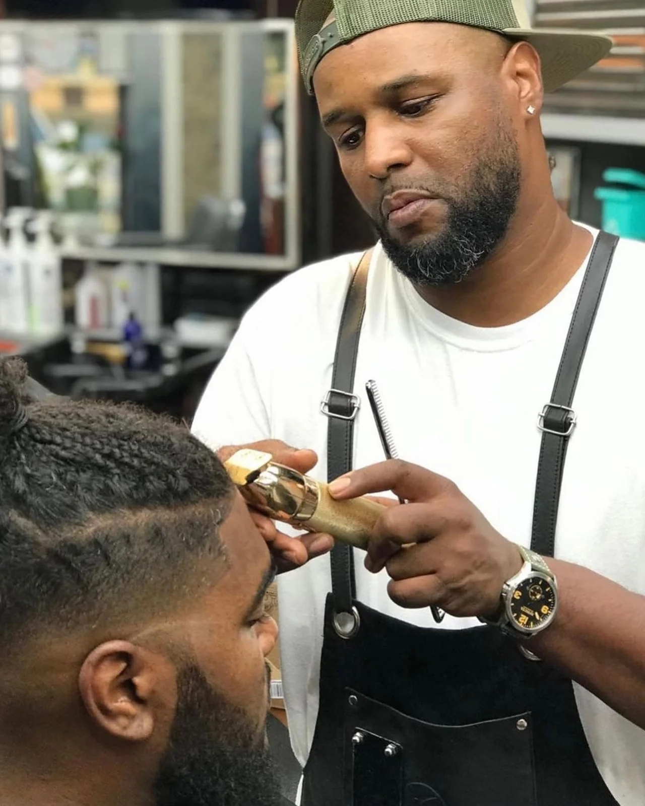 An adult customer receiving a haircut at The Cutting Edge