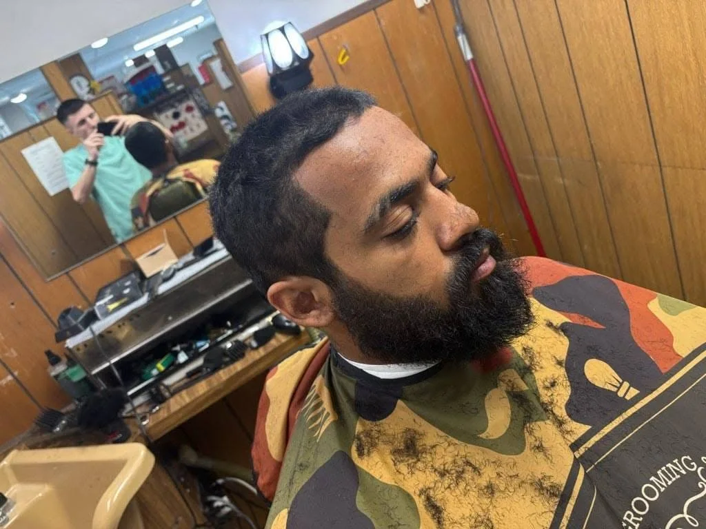 Customer's trimmed beard and haircut inside the shop